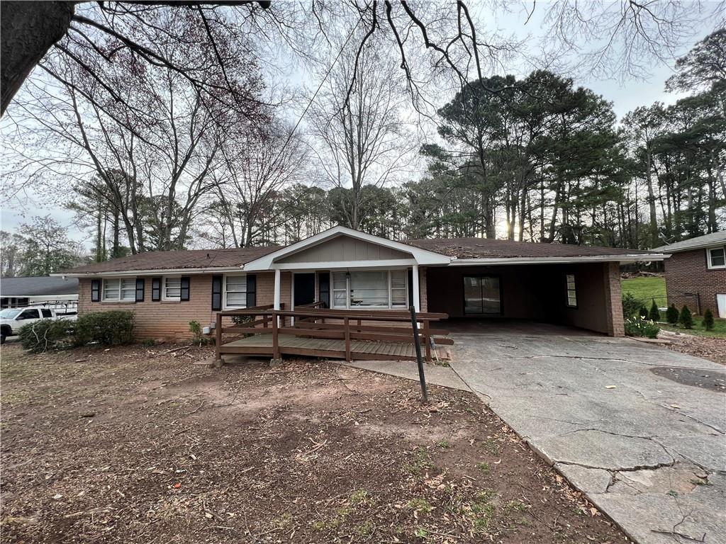 1386 Panola Road Stone Mountain, GA 30088 - Photo 1 of 1 a front view of a house with garden