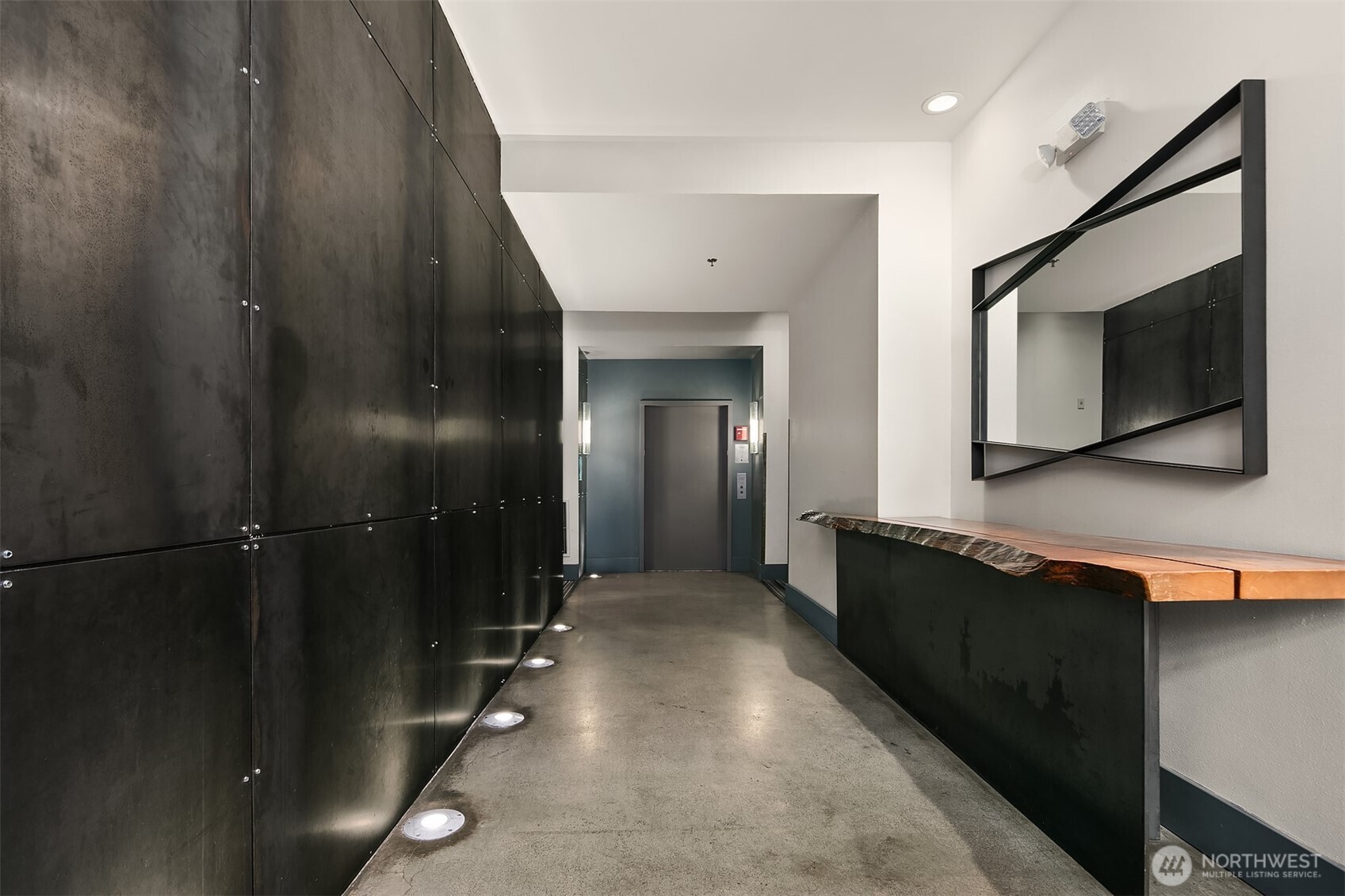 1812 19th Avenue, Unit 103 Seattle, WA 98122 - Photo 2 of 14 a hallway with a large mirror in it