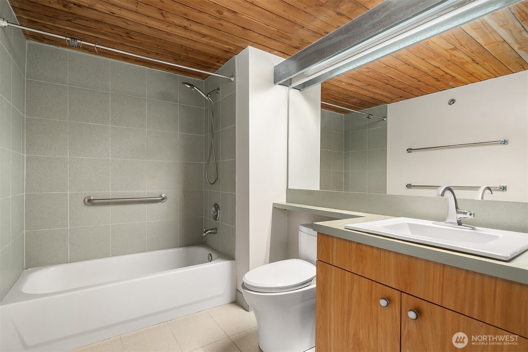 1812 19th Avenue, Unit 103 Seattle, WA 98122 - Photo 10 of 14 a bathroom with a sink a toilet and shower