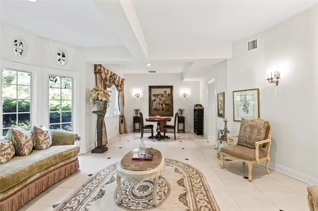 a living room with furniture and a dining table with rug