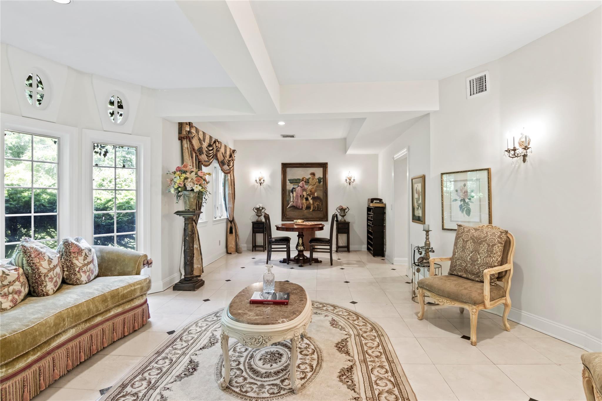 358 Centre Island Road Centre Island, NY 11771 - Photo 12 of 39 a living room with furniture and a dining table with rug