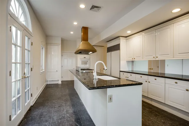 a kitchen with stainless steel appliances granite countertop a sink stove and cabinets