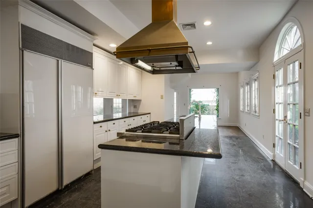 a kitchen with stainless steel appliances granite countertop a sink a stove and a refrigerator