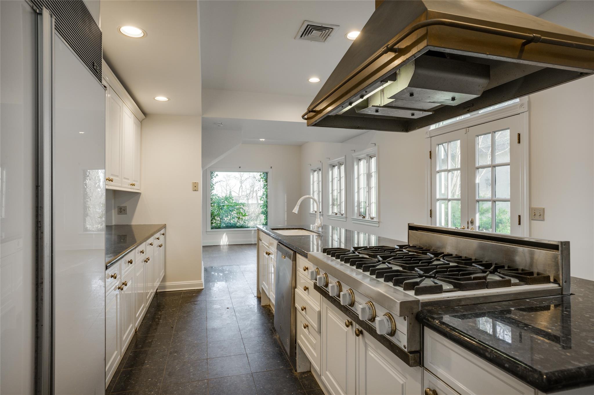 358 Centre Island Road Centre Island, NY 11771 - Photo 19 of 39 a kitchen with stainless steel appliances granite countertop a stove and a wooden floors