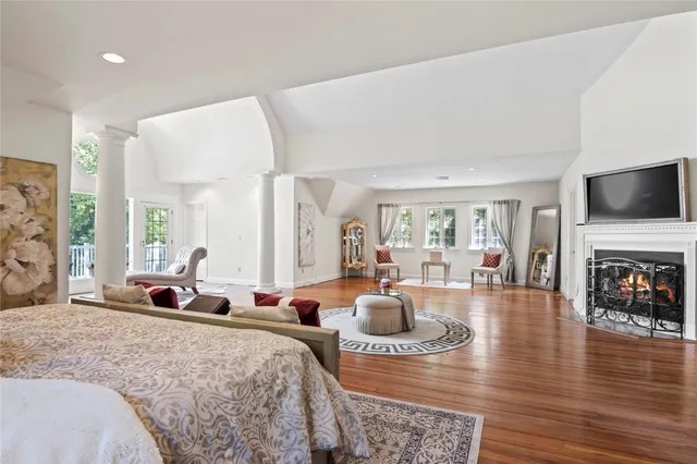a living room with furniture large window and a fireplace