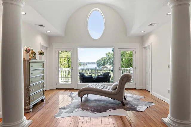 a living room with furniture fireplace and a large window