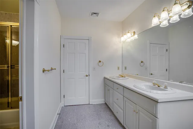 a bathroom with a double vanity sink and a mirror
