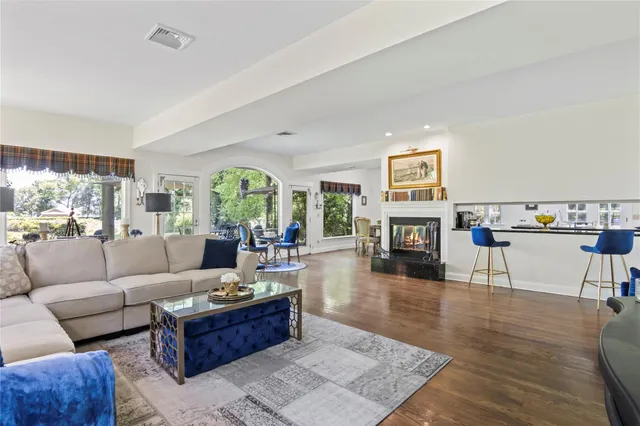 a living room with fireplace furniture and a wooden floor