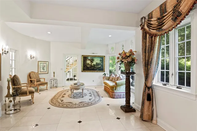 a living room with furniture a dining table and a large window