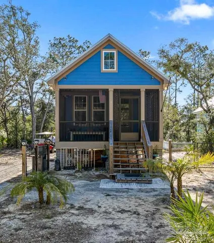 a view of a house with a door and a yard