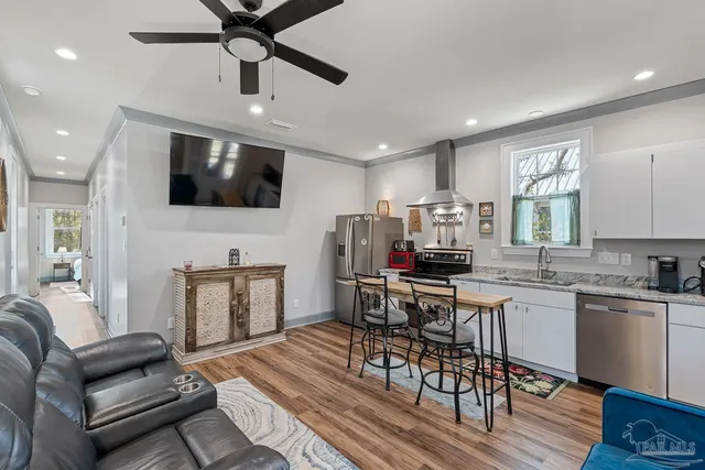 a kitchen with a stove a sink and cabinets