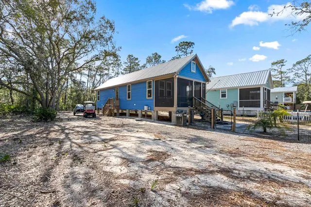 a street sign on a sidewalk next to a road