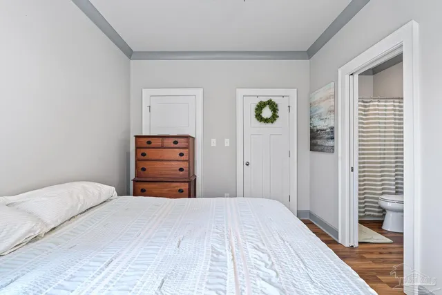 a bedroom with a bed and a dresser