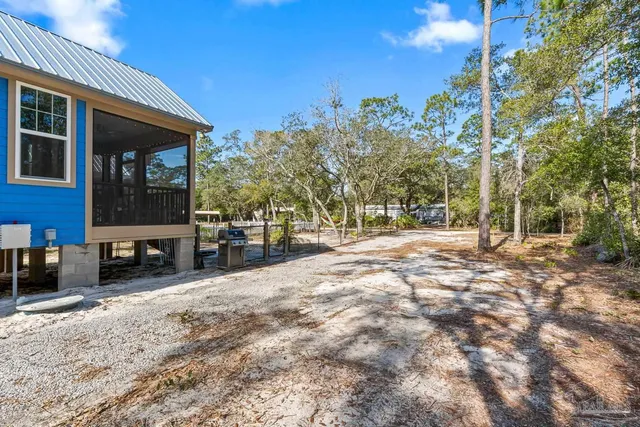 a view of balcony with wooden floor and barbeque oven