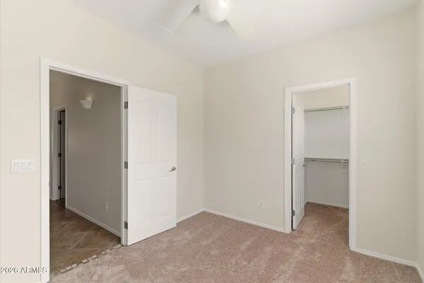 a view of a big room with closet and a ceiling fan