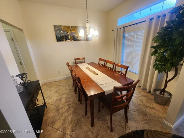 a view of a dining room with furniture and a potted plant