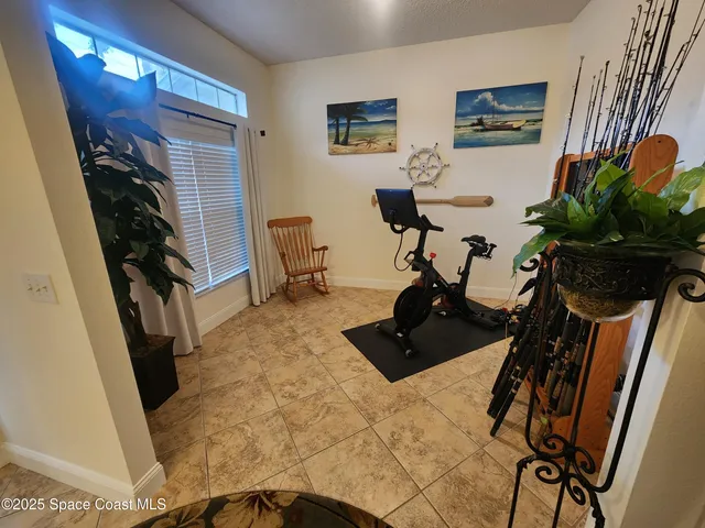 a view of a workspace with furniture and a potted plant