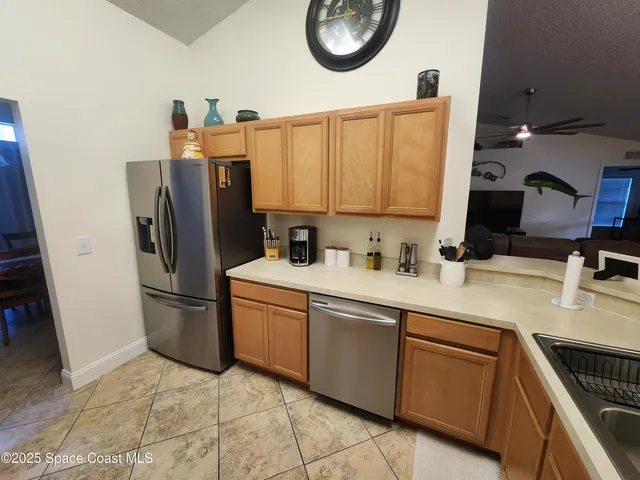 a kitchen with stainless steel appliances a refrigerator sink and microwave