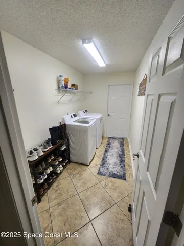 a room with a baby crib and a couch