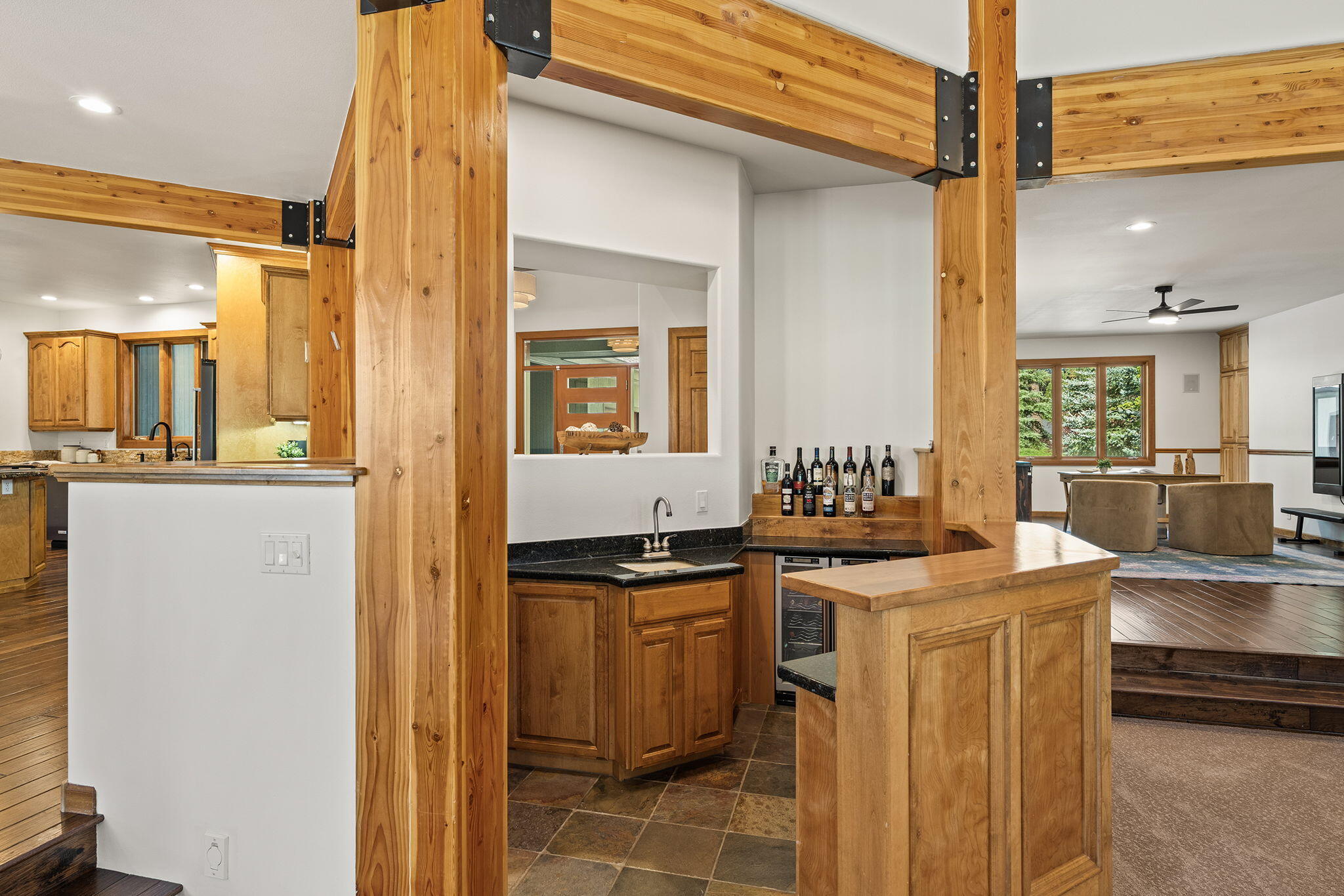60766 Golf Village Loop Bend, OR 97702 - Photo 17 of 63 a kitchen with stainless steel appliances granite countertop a sink and a refrigerator