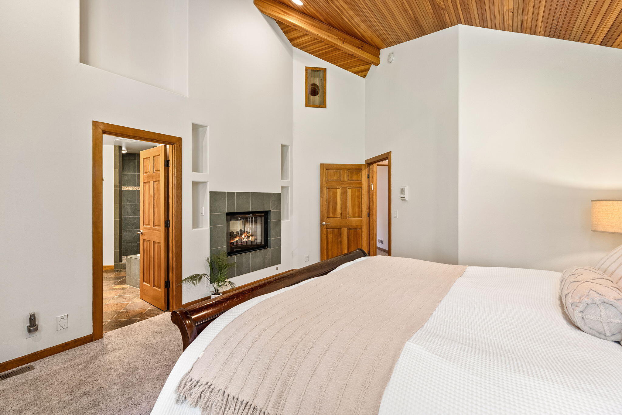 60766 Golf Village Loop Bend, OR 97702 - Photo 24 of 63 a bedroom with a bed and a fireplace