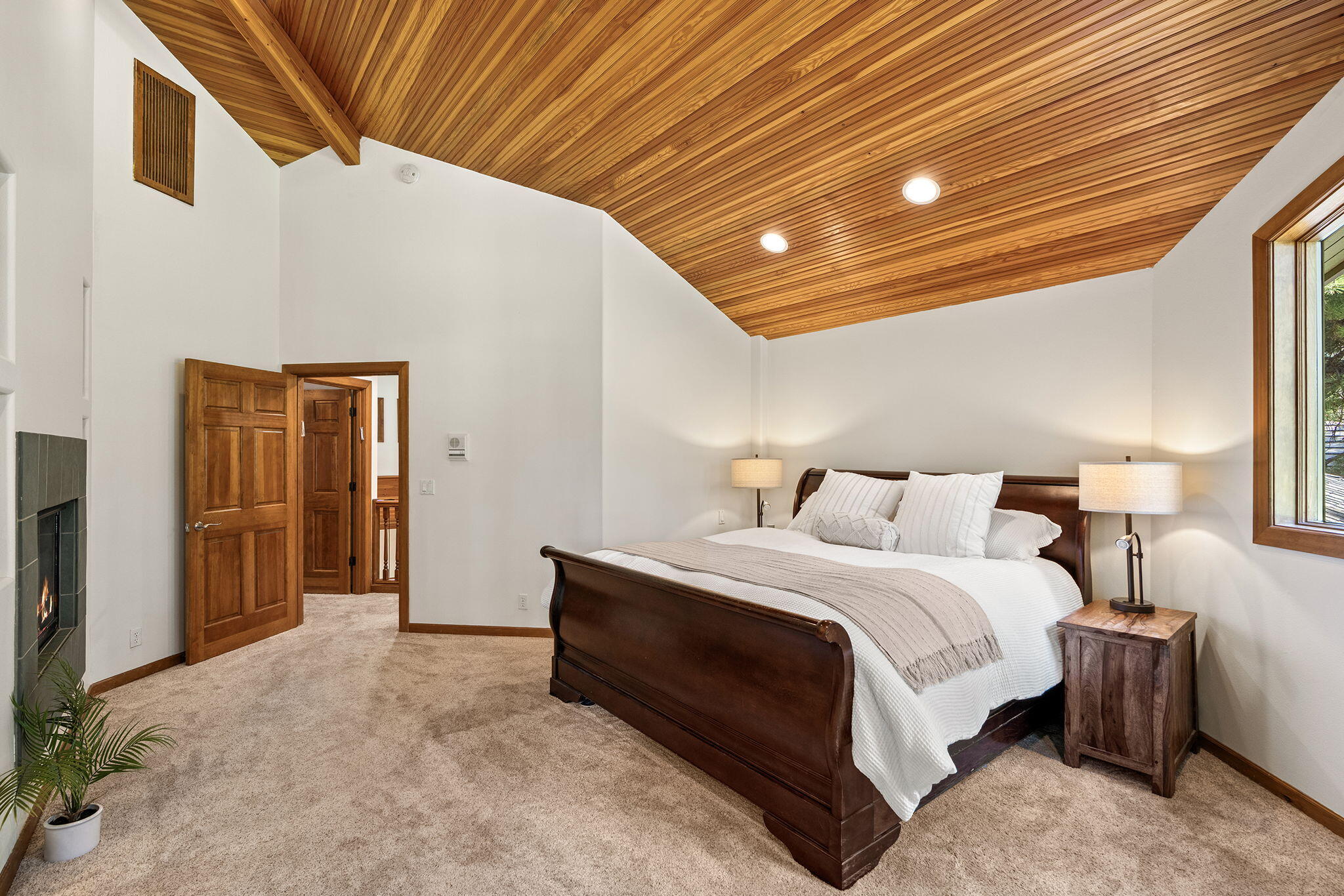60766 Golf Village Loop Bend, OR 97702 - Photo 25 of 63 a spacious bedroom with a bed and a chandelier