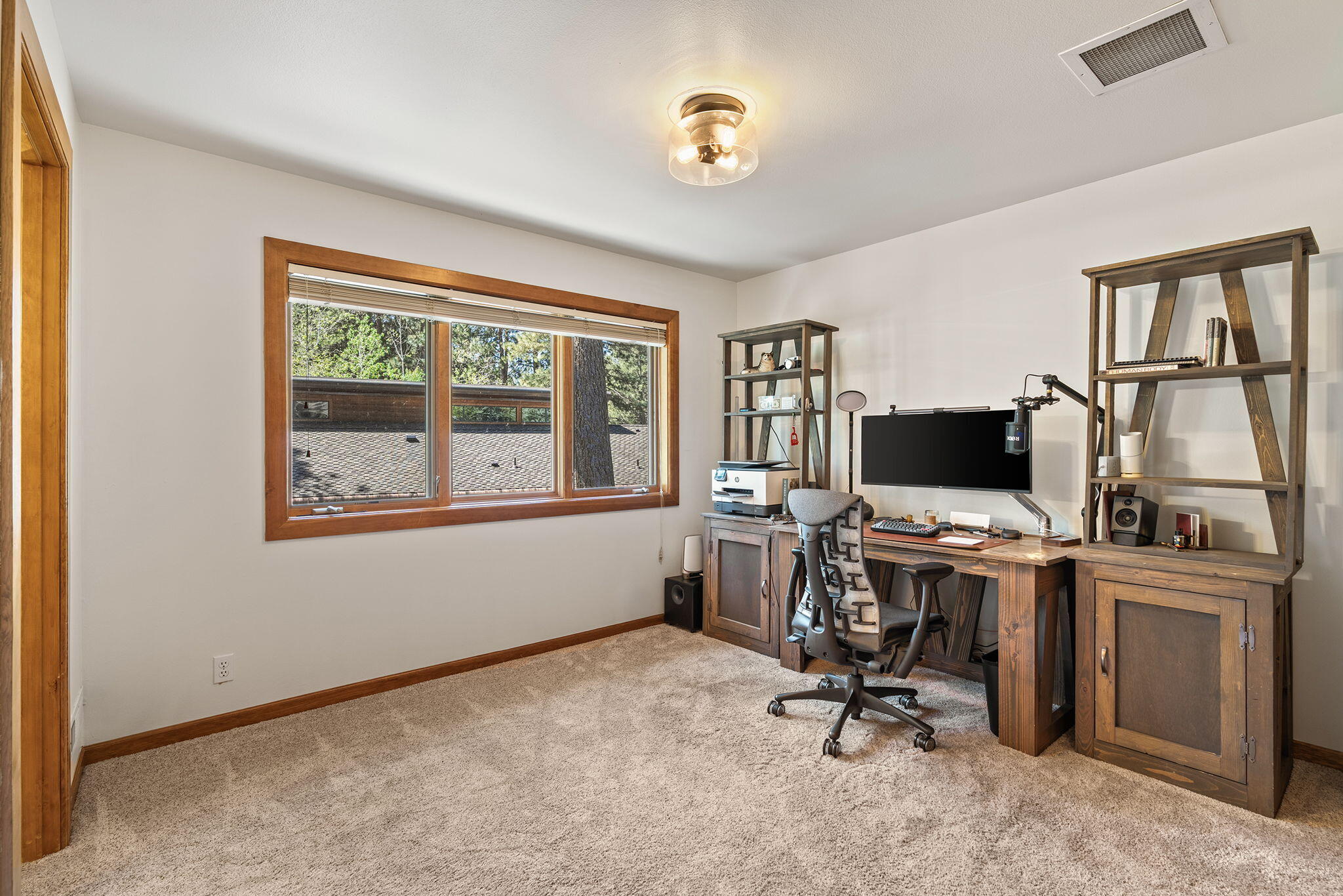 60766 Golf Village Loop Bend, OR 97702 - Photo 35 of 63 a view of a workspace with furniture and a window