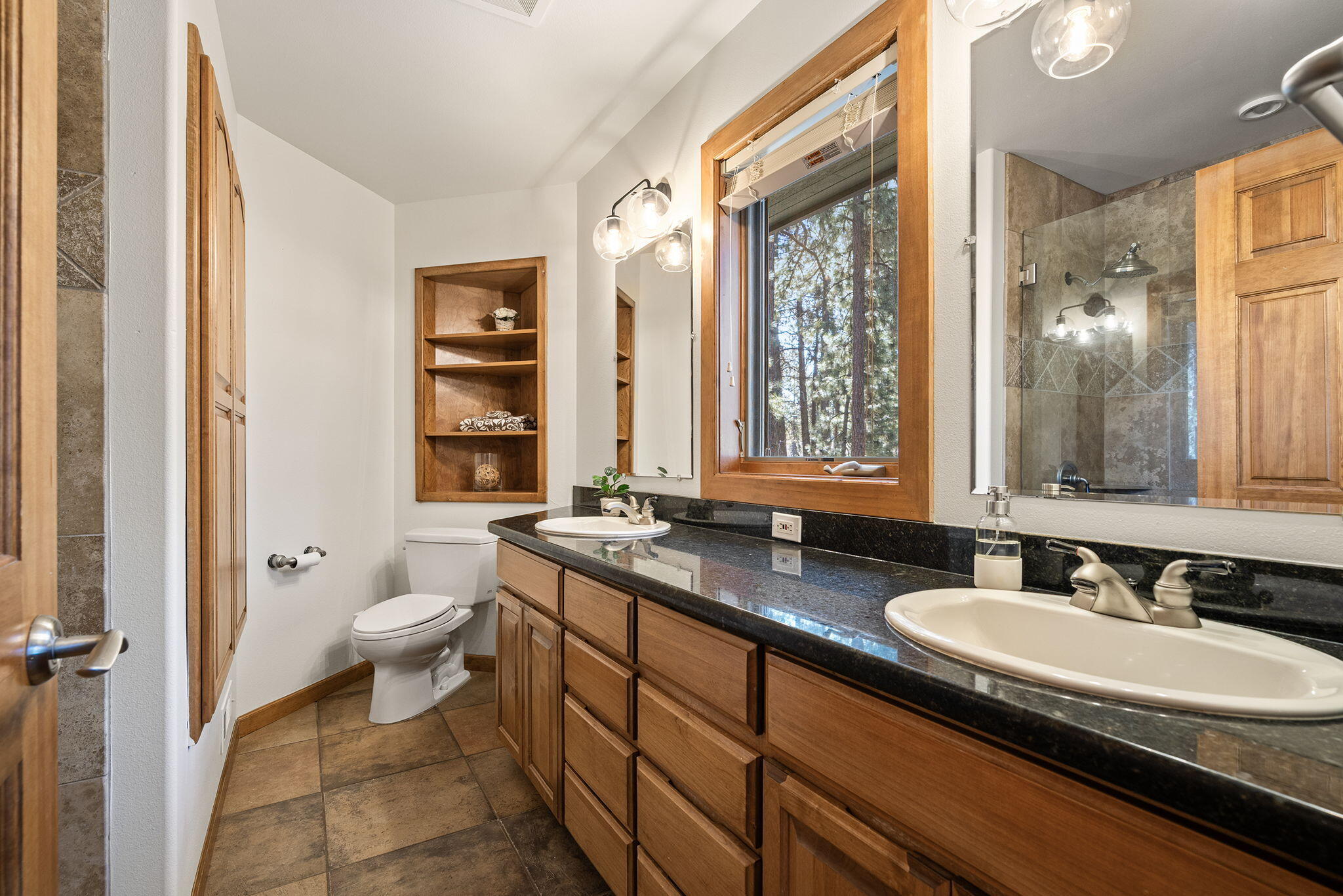 60766 Golf Village Loop Bend, OR 97702 - Photo 37 of 63 a bathroom with a granite countertop sink toilet and a mirror