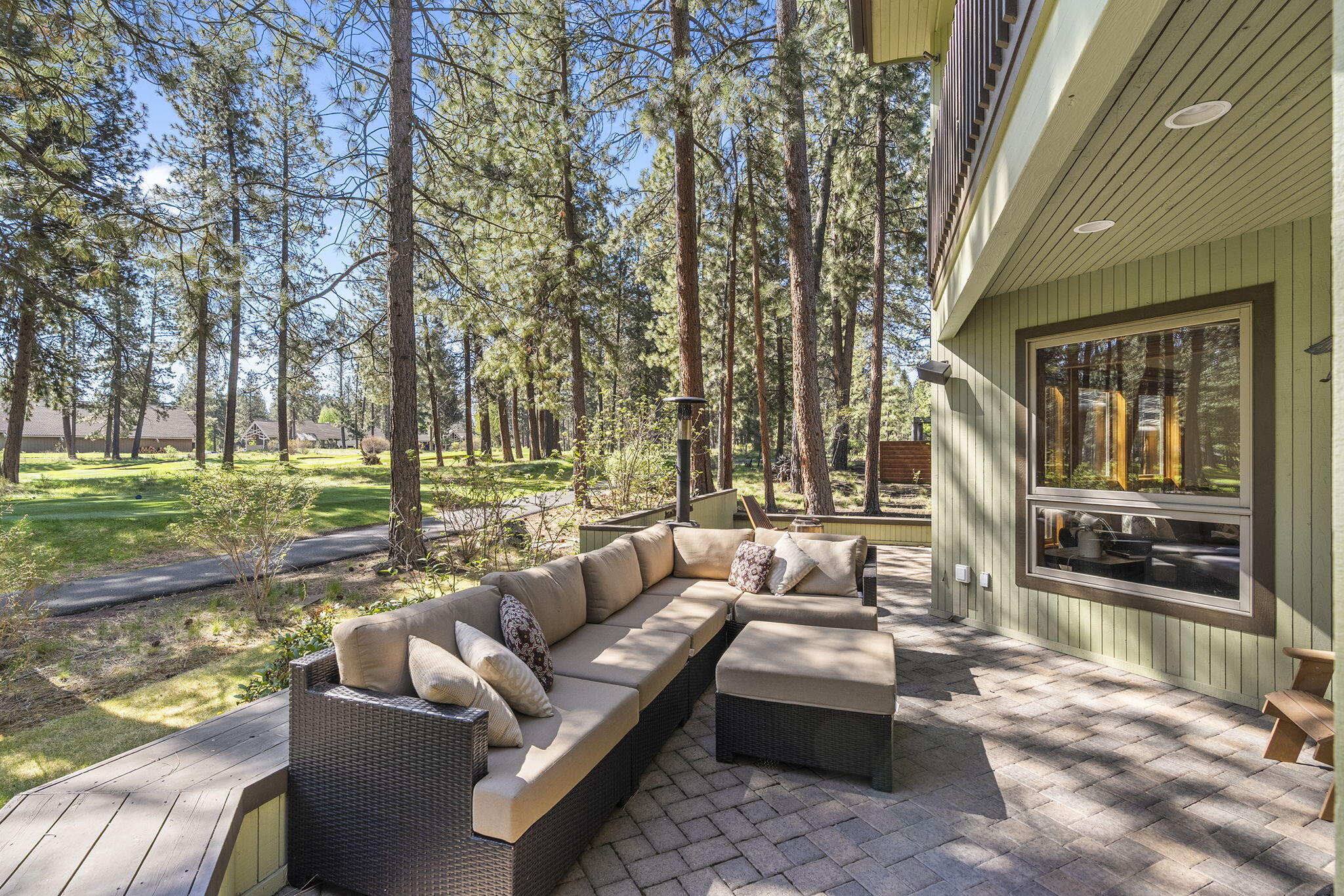 60766 Golf Village Loop Bend, OR 97702 - Photo 45 of 63 a view of a patio with couches and chairs with wooden floor and fence