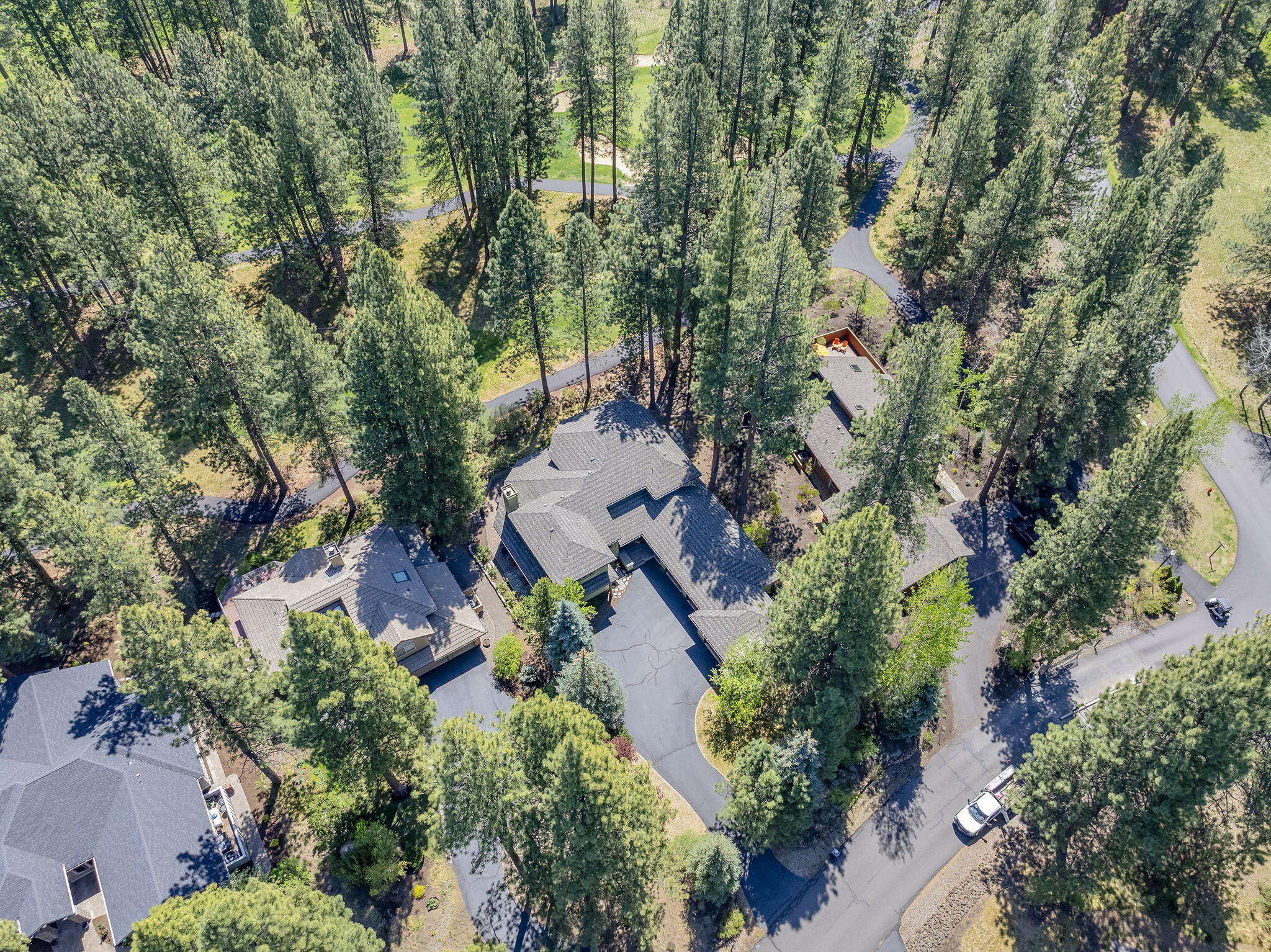 60766 Golf Village Loop Bend, OR 97702 - Photo 48 of 63 an aerial view of a house with yard and outdoor seating
