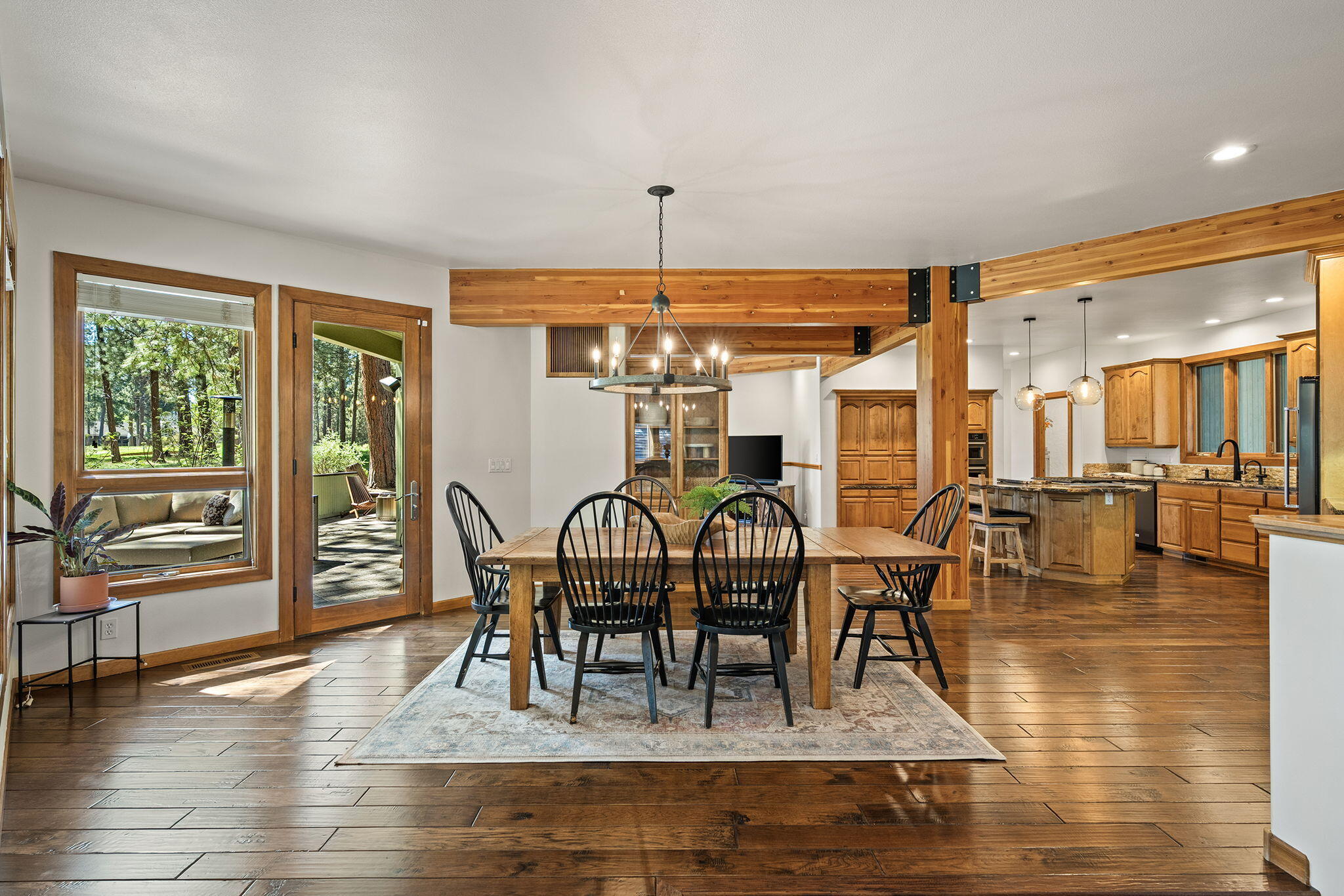 60766 Golf Village Loop Bend, OR 97702 - Photo 7 of 63 a view of a dining room with furniture window and wooden floor