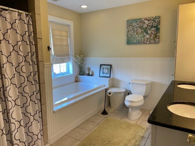 432 Quassapaug Road Woodbury, CT 06798 - Photo 11 of 21 a bathroom with a toilet and a shower curtain
