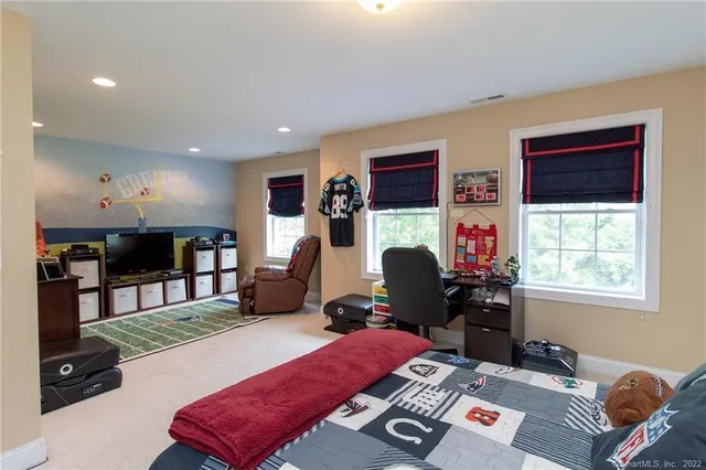 a room with furniture a flat screen tv and a window