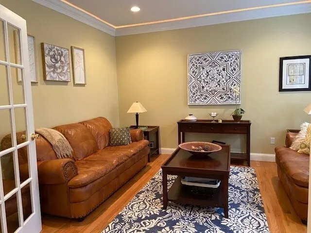 a living room with furniture and a piano