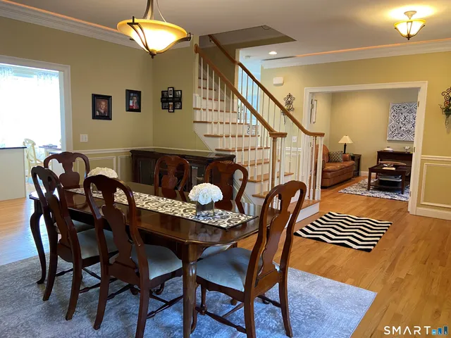 a dining room with furniture and wooden floor
