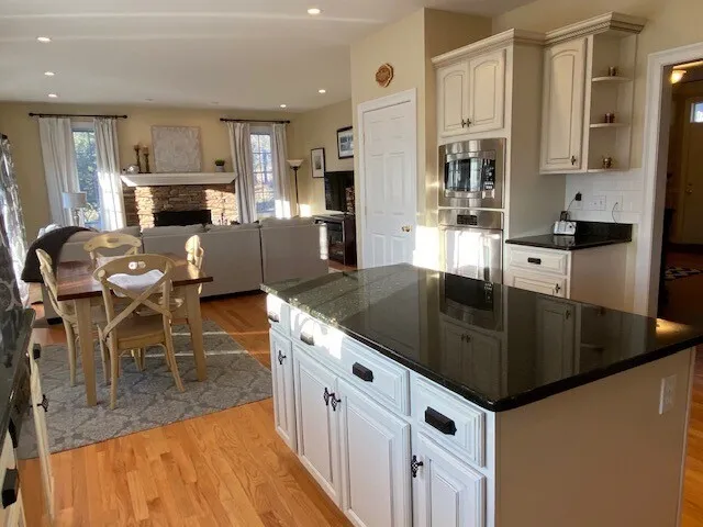 a kitchen with stainless steel appliances granite countertop a sink a stove top oven a counter space and cabinets