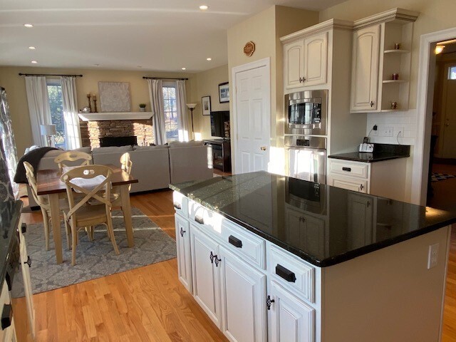 432 Quassapaug Road Woodbury, CT 06798 - Photo 7 of 21 a kitchen with stainless steel appliances granite countertop a sink a stove top oven a counter space and cabinets