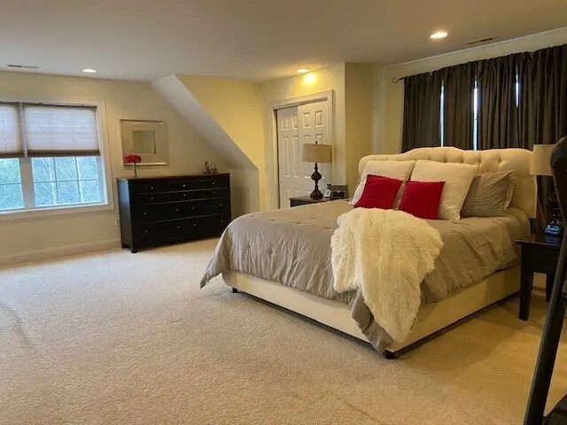 a spacious bedroom with a bed and furniture