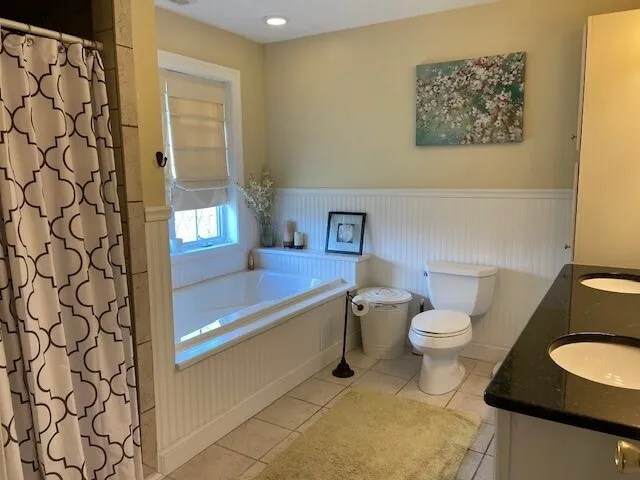 a bathroom with a toilet and a shower curtain