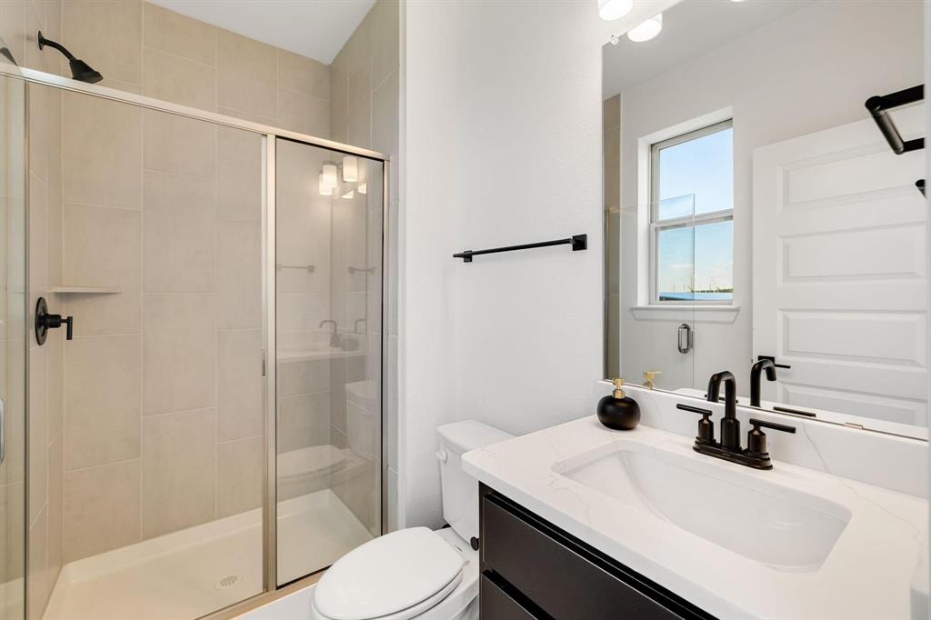 9303 Easy Street Rowlett, TX 75088 - Photo 9 of 33 a bathroom with a sink toilet and shower