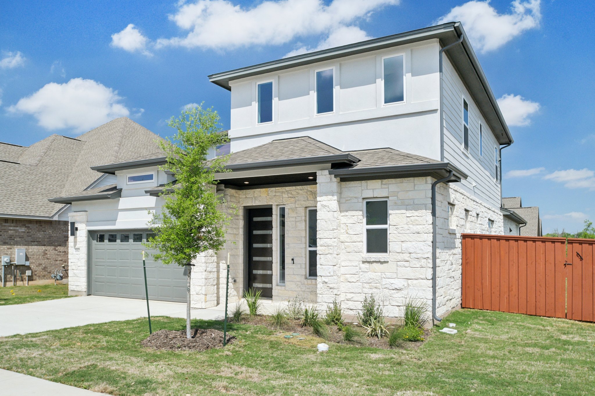 1660 Cardinal Lane Round Rock, TX 78681 - Photo 2 of 35 a view of a white house with a yard and plants