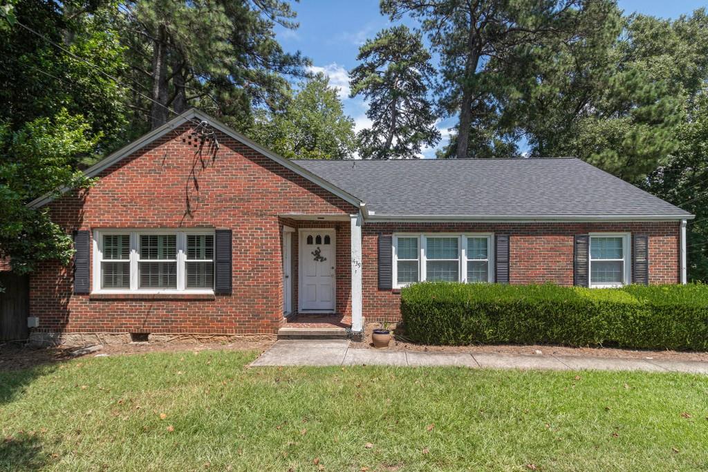 1439 Clairmont Road Decatur, GA 30033 - Photo 1 of 1 a front view of a house with a yard and trees