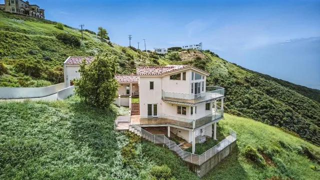 an aerial view of a house with a yard