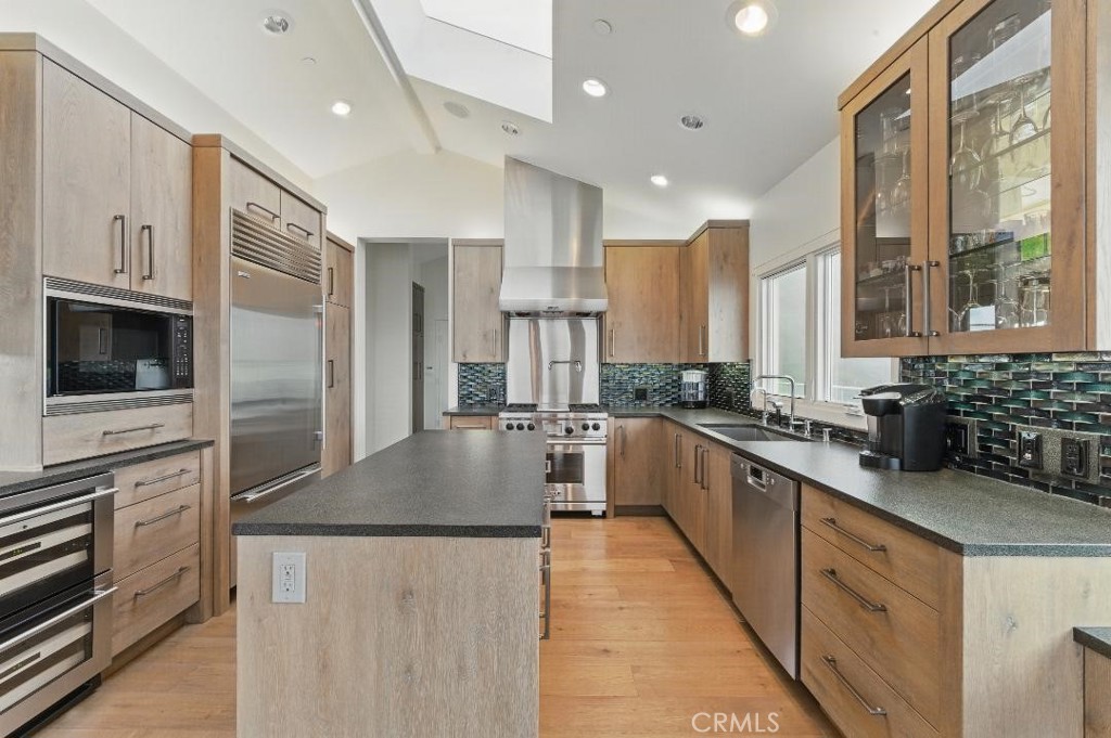 2501 Barrymore Drive Malibu, CA 90265 - Photo 12 of 54 a large kitchen with stainless steel appliances kitchen island granite countertop a large counter top stainless steel appliances and cabinets