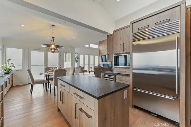 a large kitchen with kitchen island a sink table and chairs