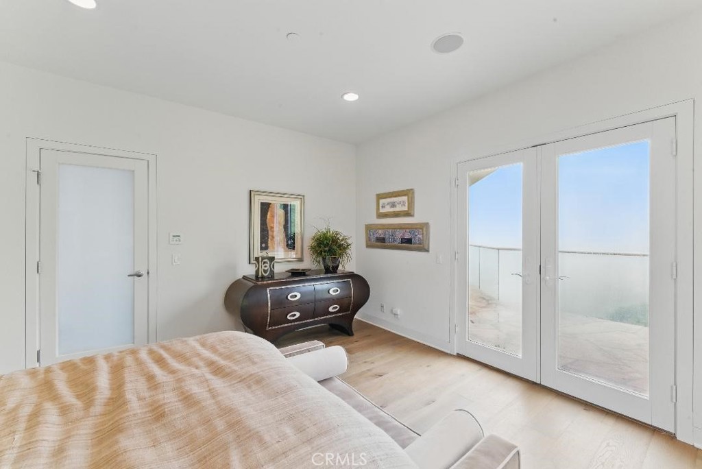 2501 Barrymore Drive Malibu, CA 90265 - Photo 18 of 54 a bedroom with a bed and wooden floor