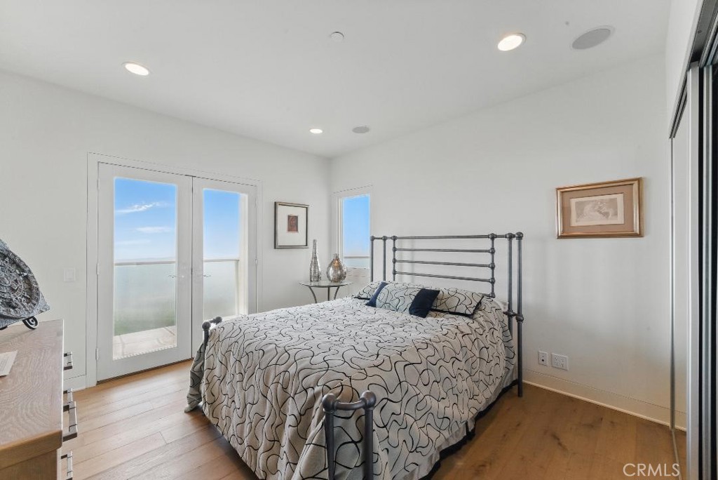 2501 Barrymore Drive Malibu, CA 90265 - Photo 22 of 54 a bedroom with a bed and wooden floor