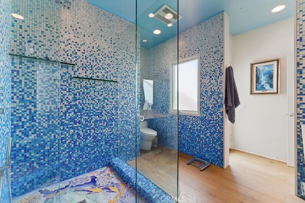 2501 Barrymore Drive Malibu, CA 90265 - Photo 24 of 54 a bathroom with a toilet and a shower curtain