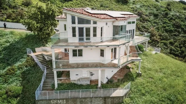 a aerial view of a house with a fountain in front of house