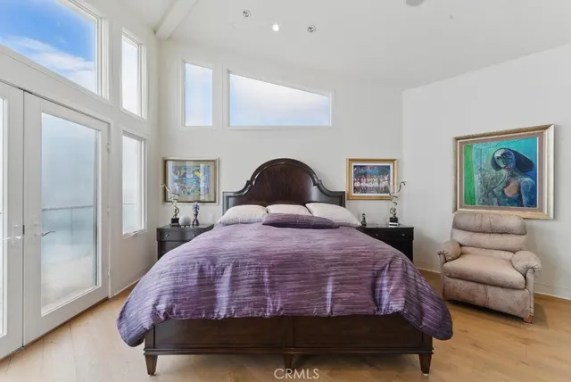 a bedroom with a large bed and a flat screen tv
